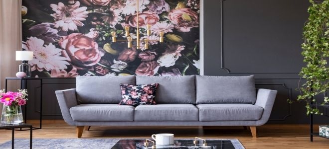 Grey sofa with dark grey wall and floral wallpaper behind it