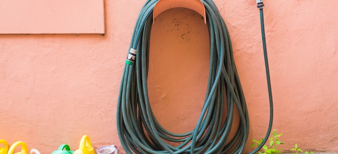 A hose hanging on a post.