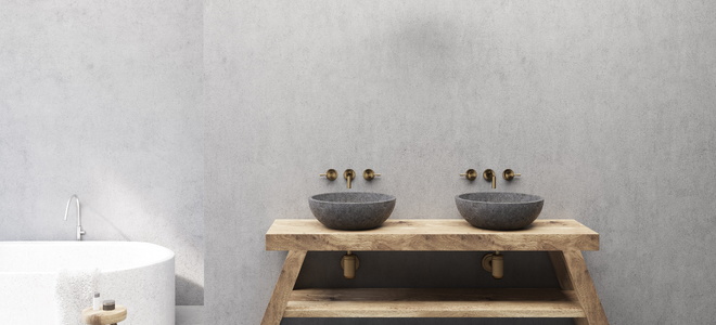 A bathroom with concrete sinks.