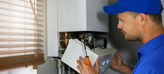 man repairing water heater
