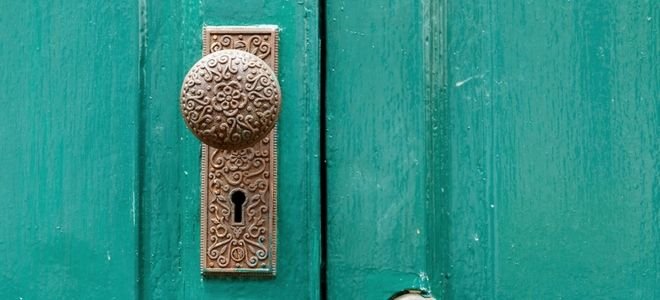 closeup of a teal door with doorknob