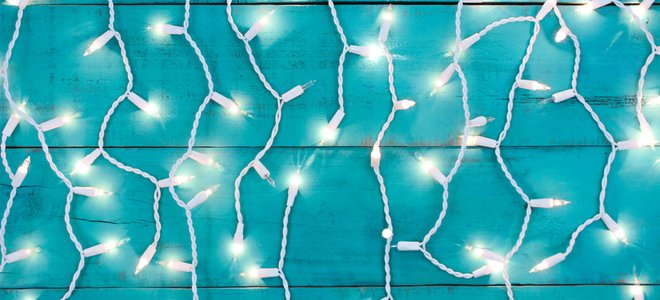 White Christmas lights against a blue background.