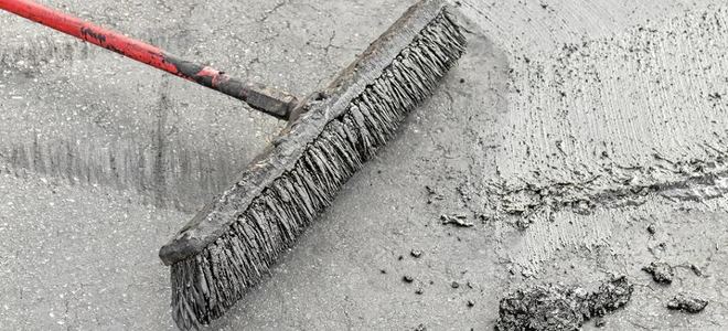 A broom resurfacing wet concrete.