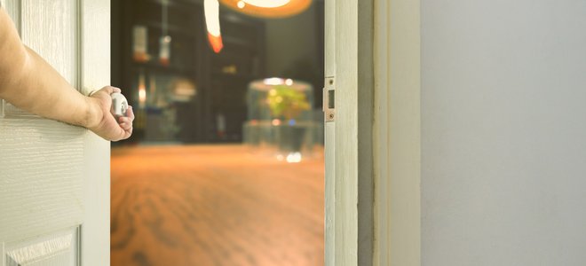 an arm opening a door