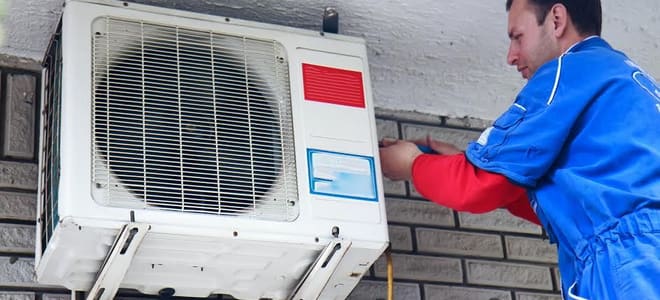An air conditioner tech inspecting the unit. 