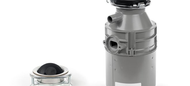 The pieces of a garbage disposal unit isolated on a white background.