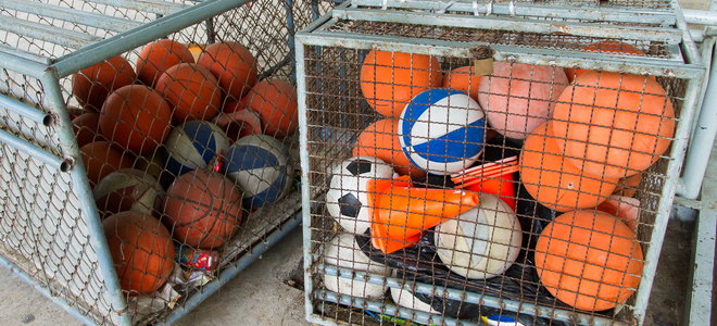 Storage containers with sports balls.