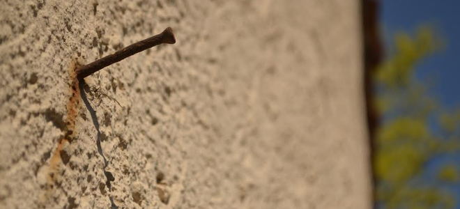A nail in a stone wall. 