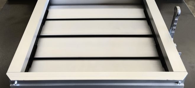 metal fire damper that looks like a square vent with tilted covers