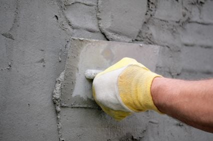man creating a stucco wall