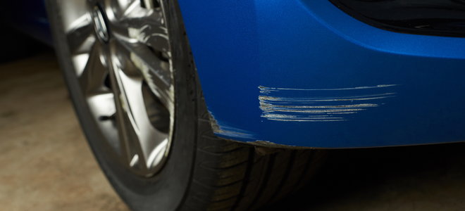 A blue car with scratches on it.