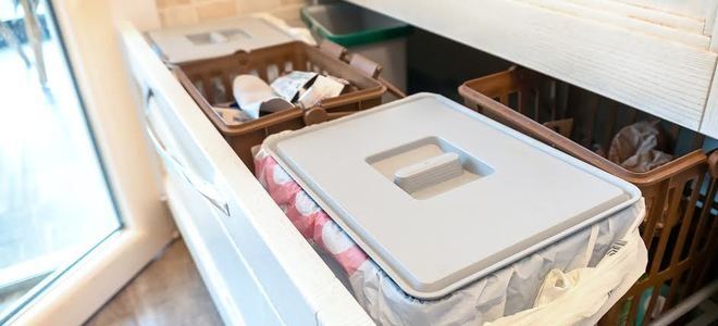 a trash compactor in a pull out cabinet