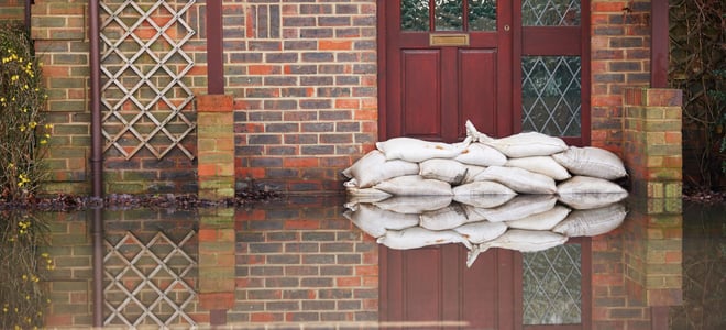 Sandbags in front of a flooded building.