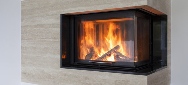 A modern fireplace encased in glass. 