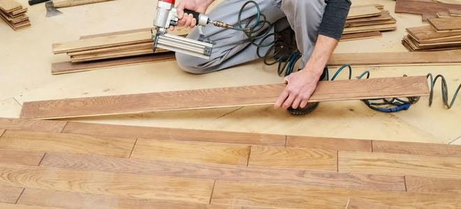 a man installing vinyl plank flooring