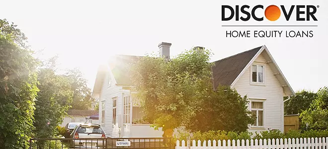 A home with a sun riding behind it