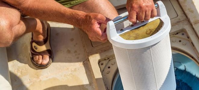 person removing pool filter
