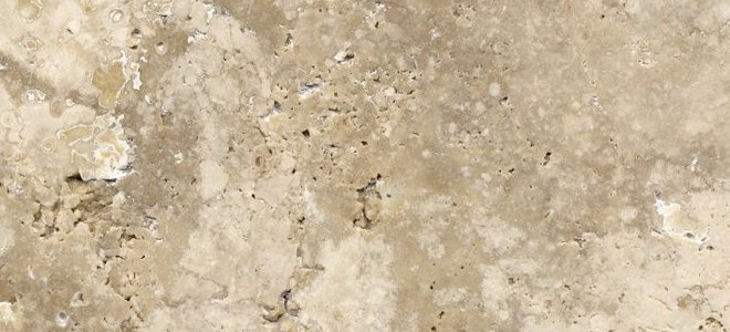 A close-up of the texture of travertine tile.