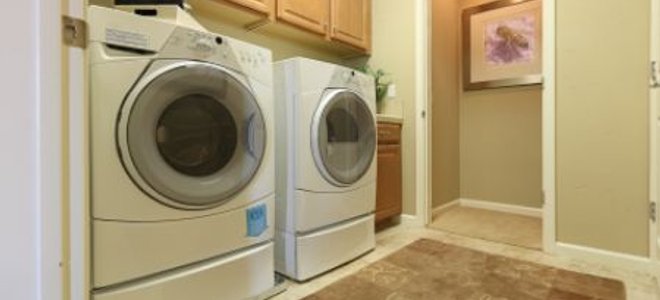 A laundry room with a washer and dryer side-by-side.
