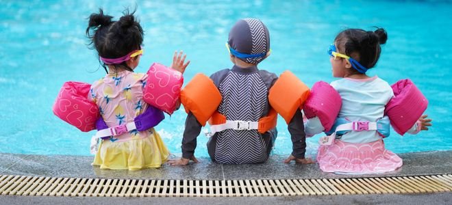 Three kids at a pool.