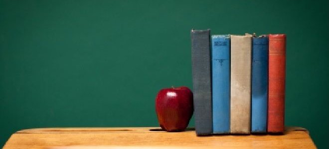 desk with apple and books on top