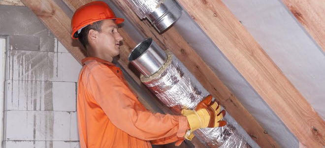 man working on a metal duct