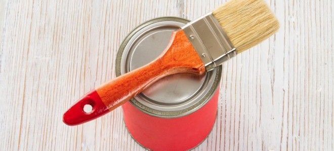 paint brush in a can of stain