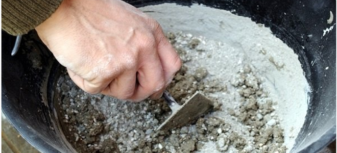 man mixing concrete in a bucket