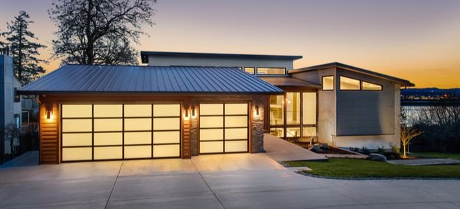 Home with garage lit up inside and out