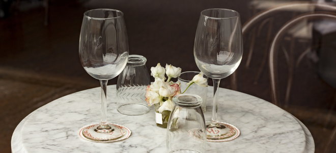 A marble table with wine glasses on it.