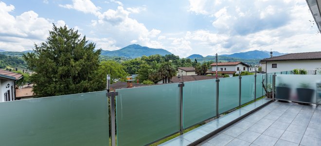 Upper deck with glass railing and a view