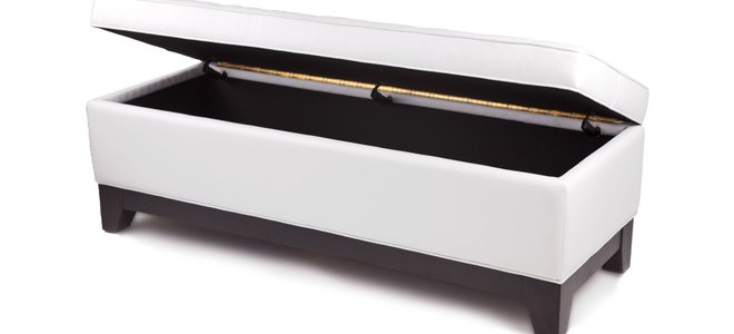A white storage ottoman on a white background.