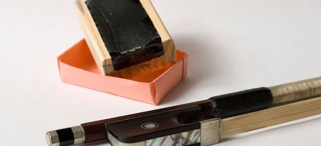 violin rosin next to bow