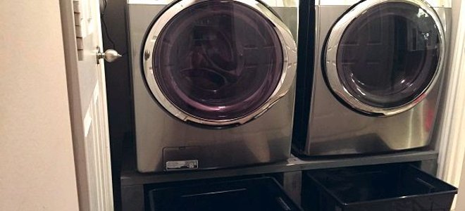 washer and dryer on pedestal with bins
