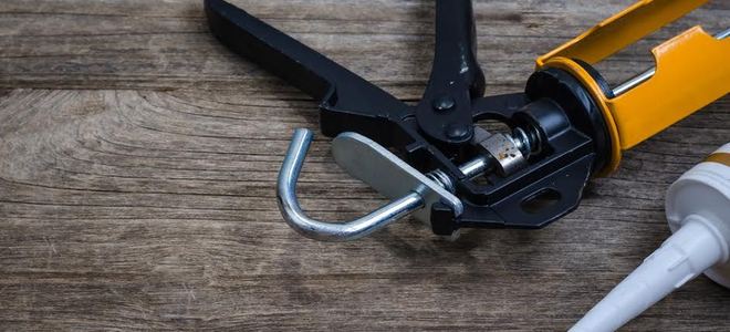 caulking gun and tube of caulk