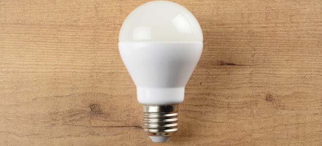 An LED bulb against a wood background. 
