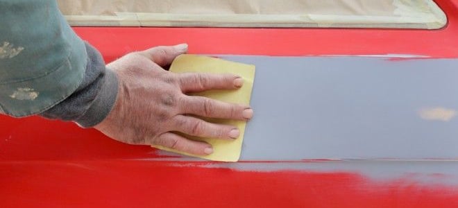 sanding primer on a red car