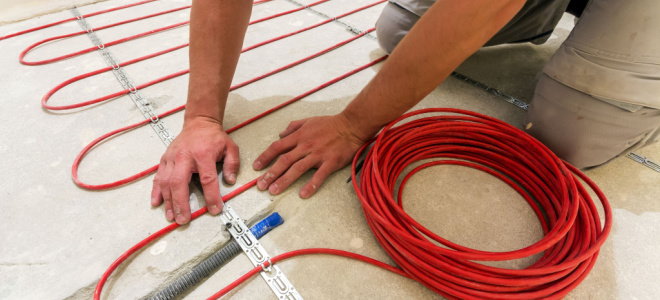 person laying radiant heat flooring