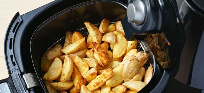 air fryer with potato chunks
