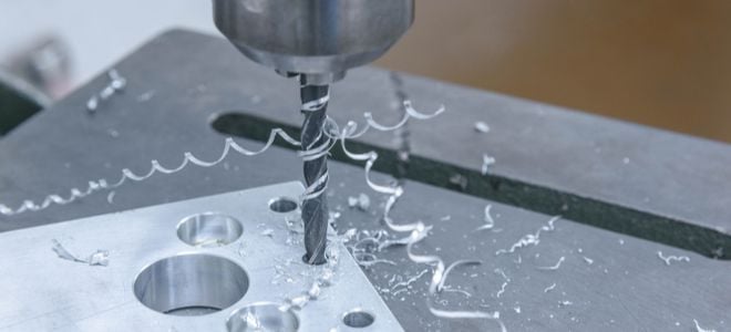drill press drilling holes in metal