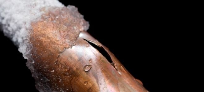 A burst copper pipe with ice on it. 