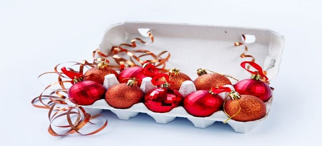 Red Christmas ornaments stored in an egg carton. 