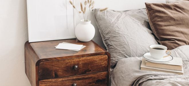natural tones in bedside table next to comfortable bed