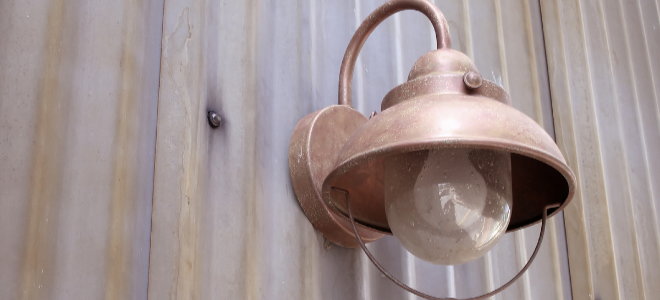 copper outdoor light fixture on the side of a building