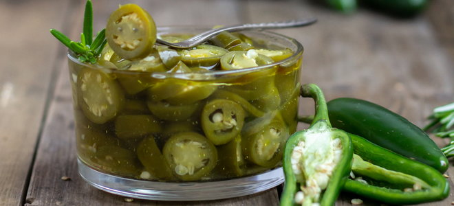 cut jalapenos pickling in a glass jar