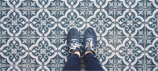 legs with sneakers standing on tile