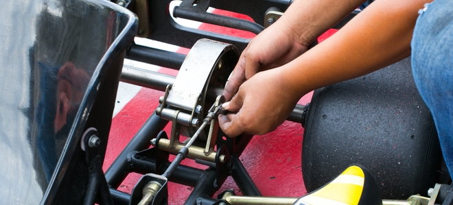 person working on a go kart