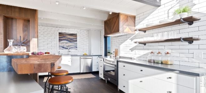 tiled kitchen with stools and floating shelves