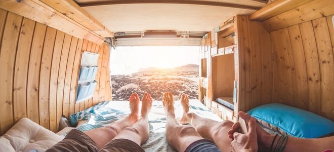 two people’s legs in the back of a wood truck bed camper