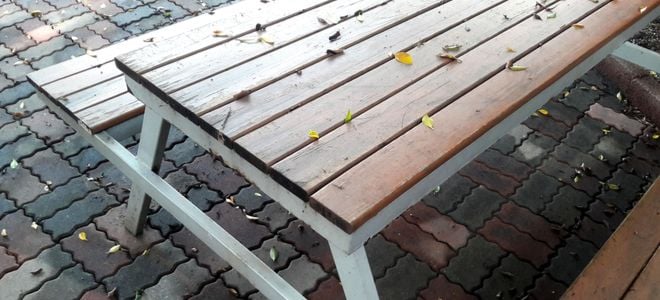 wood picnic table on brick patio